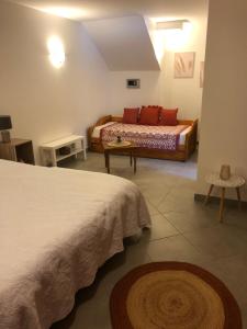 a hotel room with two beds and a table at Chamalobri in Labeaume