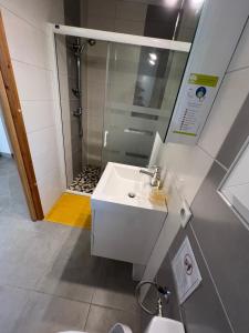 a bathroom with a white sink and a shower at Chamalobri in Labeaume