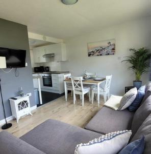 a living room with a couch and a table at Cosy Cabin in Bucks Mills