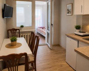 a kitchen and dining room with a table and chairs at Admiral aqua resort in Mielno