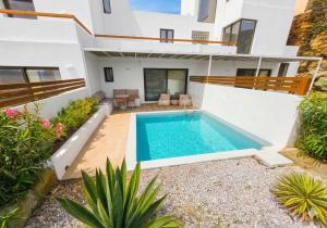 an image of a swimming pool in a house at Aura Sun Villa in Agios Romanos