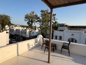 a patio with two chairs and a table on a balcony at CİELO Otel in Bodrum City