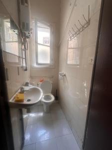 a bathroom with a toilet and a sink at Chambre du jardin in Rabat