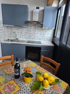 a kitchen with a table with fruit on it at Lemon House in Avola +4 photos