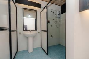 a bathroom with a sink and a shower at Sahana beach in Galle