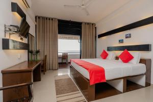 a hotel room with a bed and a desk at Sahana beach in Galle