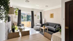 a living room with a couch and a table at Arzella Apartments Xlendi, Premium 2BR, Bus Stop & Market Opposite in Xlendi