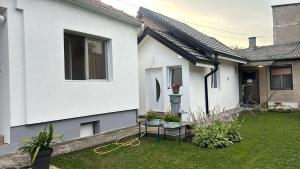 a white house with a green yard with plants at Sweet home Jagodina in Jagodina