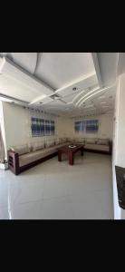 a large room with a bench and a table in it at Ajdir in Ajdir