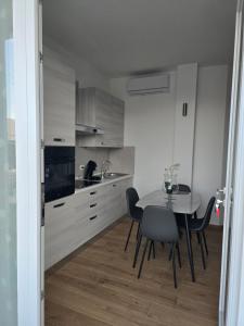 a kitchen with a table and chairs in a room at Lemon House in Avola
