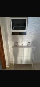 a white dresser in a room with a mirror at Ajdir in Ajdir
