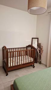 a bedroom with a crib and a vase of flowers at Veronica's House in Zagora