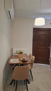 a dining room with a wooden table and chairs at Veronica's House in Zagora