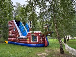 a large inflatable water slide in a park at Żeremie Jurki Camp in Jurki