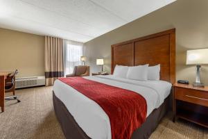 a hotel room with a large bed and a desk at Comfort Inn Cranberry Twp in Cranberry Township +30 photos