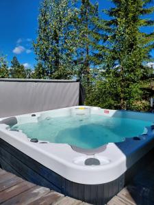 a hot tub sitting on top of a deck at Villa Laiskajaakko in Vimpeli