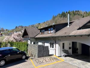 a car parked in front of a house at Stylish & modern Flat with large Sun Balcony in Bad Peterstal +8 photos
