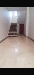 an empty room with stairs and a stair case at Ajdir in Ajdir