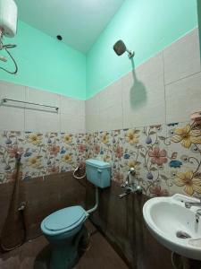 a bathroom with a toilet and a sink at Gravity Groups Core - Star residency in Pondicherry