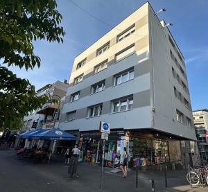 a building on a street with people walking in front of it at Cozy Aparment 4 at Cathedral in Cologne