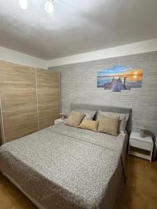 a bedroom with a bed and a painting on the wall at Castelsardo Homes in Castelsardo
