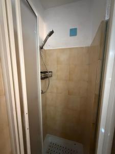 a shower with a shower head in a bathroom at Castelsardo Homes in Castelsardo +13 photos