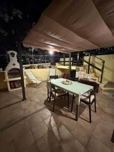a table and chairs under a tent on a patio at Castelsardo Homes in Castelsardo