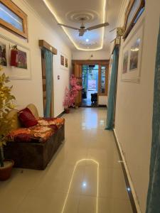 a hallway with a couch in a living room at Hotel New Heaven Canal in Srinagar