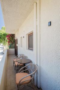 a row of tables and chairs on a balcony at Philoxenia Apartments in Karpathos