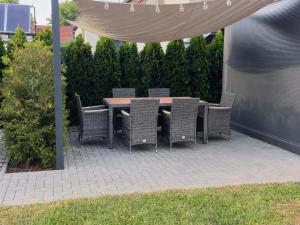 a patio with a table and chairs under a canopy at Ferienwohnung NR2 in Großräschen +3 photos