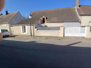 a house with a white fence and a white gate at Loft cosy 4 in city center in Saint-Benoît-sur-Loire