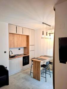 a kitchen with a table and chairs in a room at Bananas in Kumbor