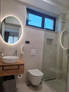 a bathroom with a toilet and a sink and a shower at Bananas in Kumbor