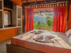 a bed in a room with a window at Bathle Eco Resort in Mawanella