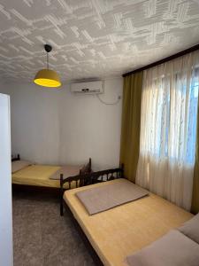 a room with two beds and a ceiling at Apartmani Becic in Sutomore