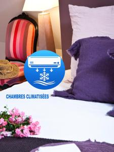 a bedroom with a bed with a blue sticker on it at L'école des garçons in Maigné