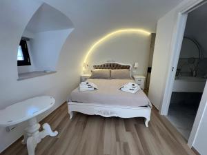 a white bedroom with a bed and a sink at Carola Luxury Room in Bari