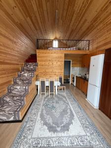 a room with wooden walls and a table and chairs at Naryn Barnhouses in Naryn