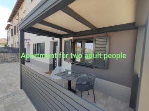 a balcony of a house with a table and chairs at Apartments SEEA in Izola