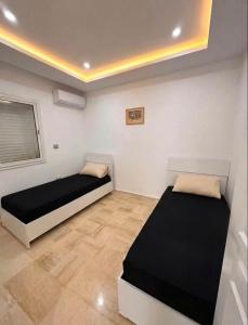 a bedroom with two beds in a room at Corail in Djerba