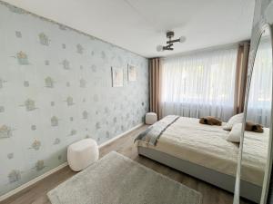 a bedroom with a bed and a window at 2-Room Apartment in Lahemaa Near the Sea in Loksa