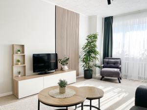 a living room with a tv and a table at 2-Room Apartment in Lahemaa Near the Sea in Loksa