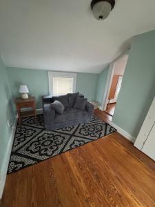 a living room with a couch and a rug at Pet friendly cottage near Boston in Canton +2 photos