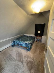 a small bedroom with a bed in a attic at Pet friendly cottage near Boston in Canton