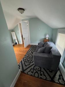 a living room with a couch and a rug at Pet friendly cottage near Boston in Canton