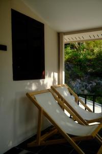 two lounge chairs in a room with a window at Flow Jungle Residency in Haad Yao