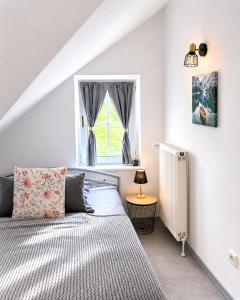 a bedroom with a bed and a window at Apartment Auszeit in Ulrichstein