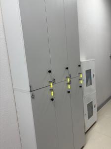 a room with white cabinets with lights on them at Astana Rooms in Astana