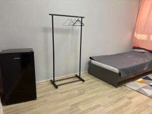a bedroom with a bed and a television in it at Astana Rooms in Astana