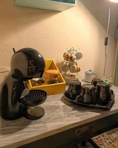a kitchen counter with a coffee maker on a table at Bricc e Foss in San Desiderio